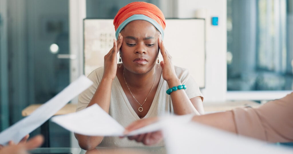 a woman in a work meeting looking stressed